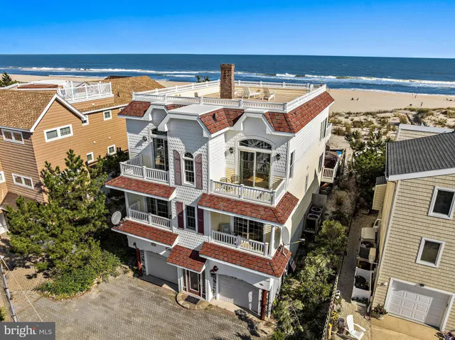 a view of a dining room with furniture and a chandelier