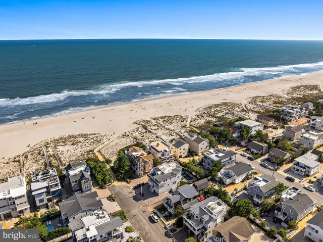 a view of game room with wooden floor and fan