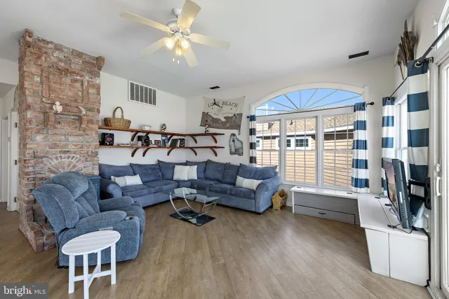 a bedroom with two large bed and a window
