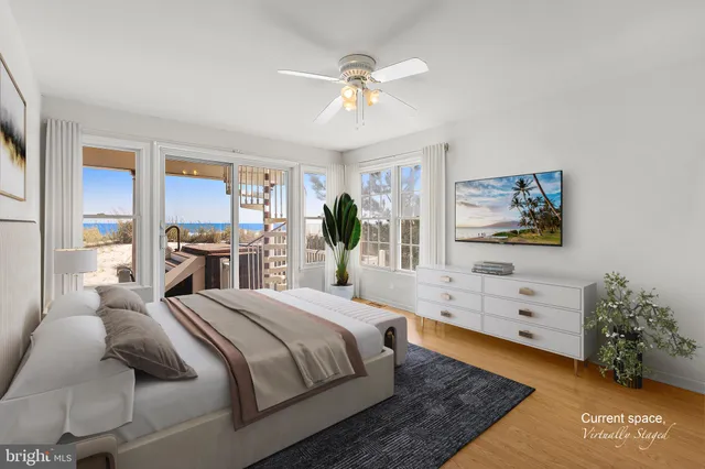a spacious bedroom with a large bed and a chandelier