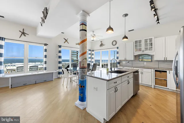 a room with pool table and windows