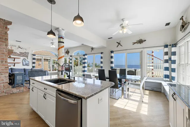 a dining room with furniture and a floor to ceiling window