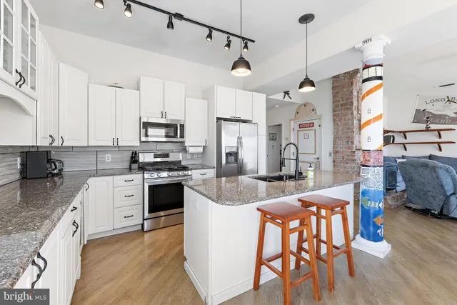 a view of a balcony with chairs and wooden floor