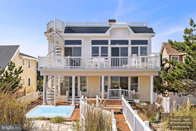 a view of a house with a chairs and table in the patio