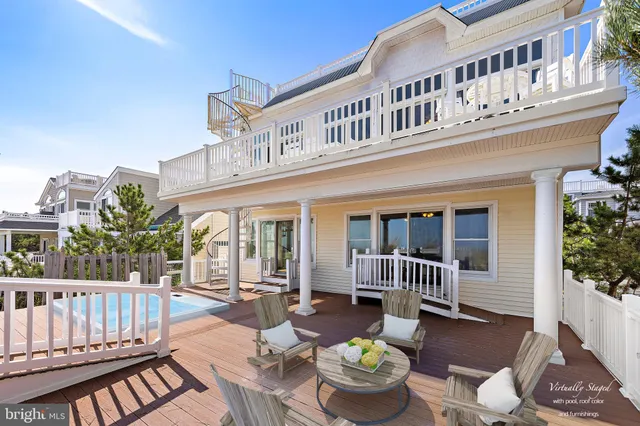 a view of a patio with wooden floor and iron fence