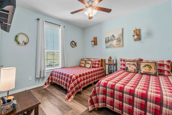 a bedroom with two beds and a window