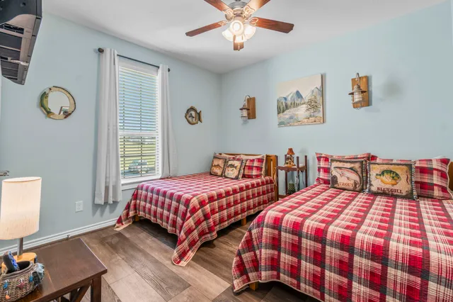 a bedroom with two beds and a window