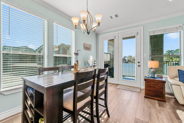 a view of a dining room with furniture wooden floor and chandelier