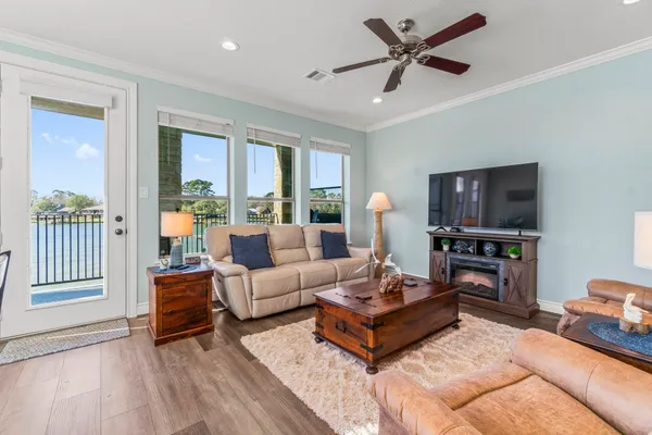 a living room with furniture a flat screen tv and a window