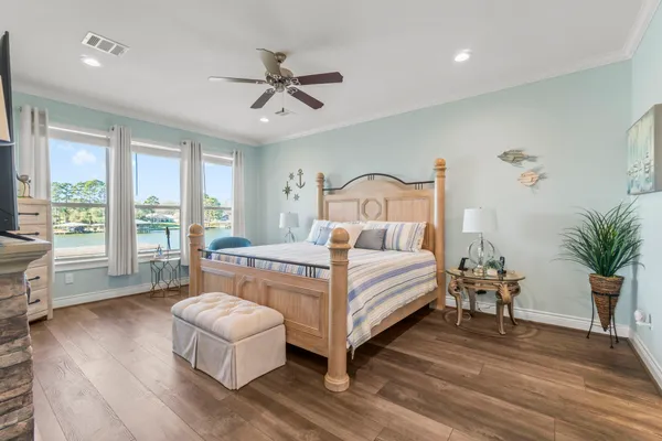 a bedroom with a large bed and a chandelier