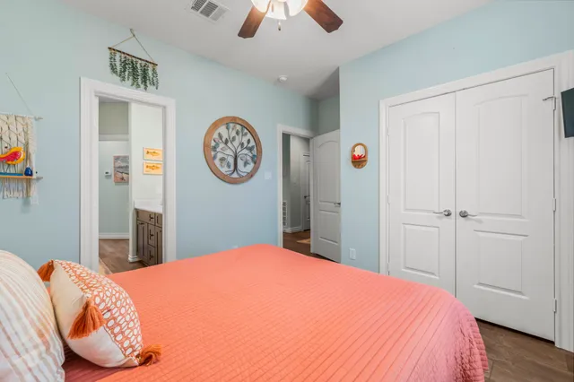 a bedroom with a bed and a chandelier