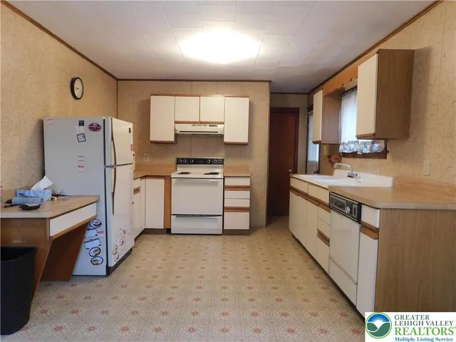 a kitchen with a sink stove and refrigerator