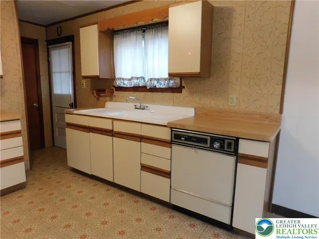 a kitchen with a sink cabinets and window