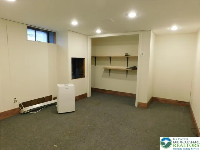 a view of an empty room with a cabinet