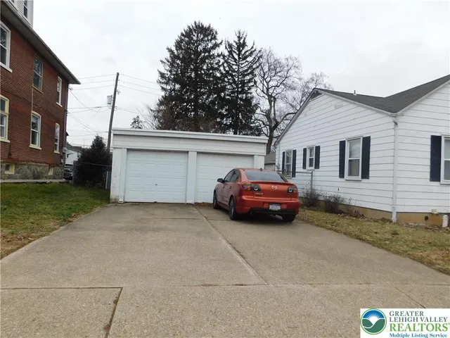 a car parked in front of a white house