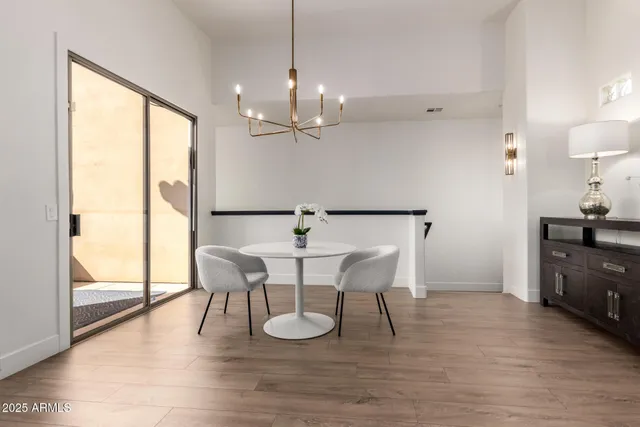 a view of a dining room with furniture wooden floor and a chandelier