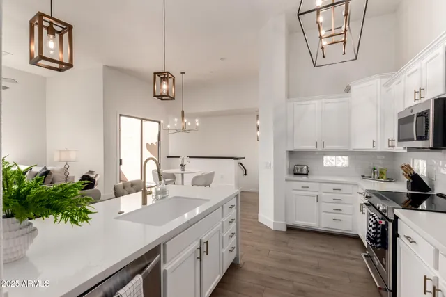 a view of a dining room with furniture a chandelier and wooden floor