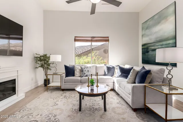 a living room with furniture a fireplace and a flat screen tv