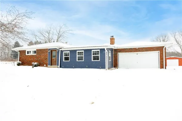 a front view of a house with large windows