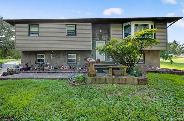 a front view of a house with patio and garden
