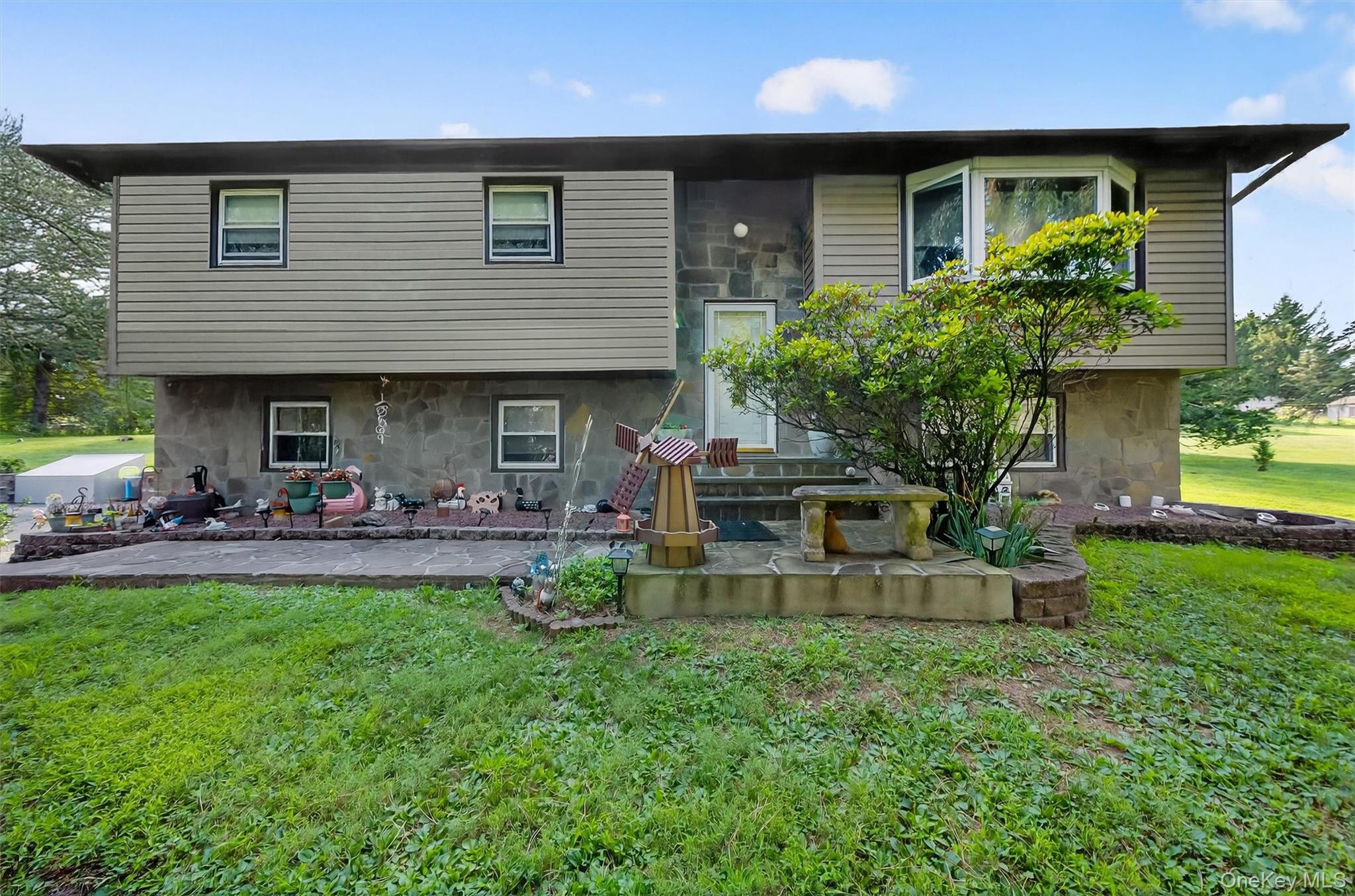 a front view of a house with patio and garden
