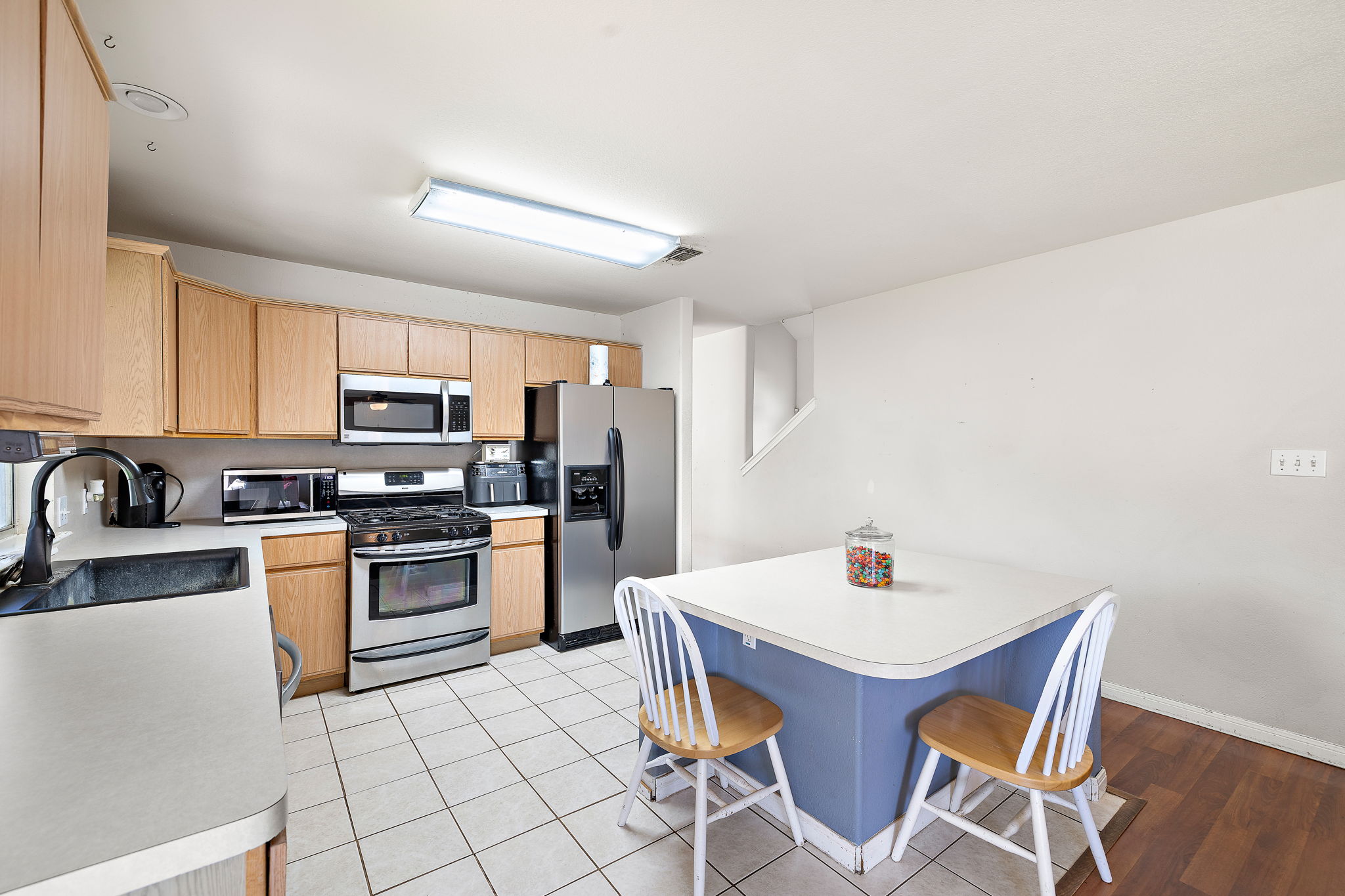 615 Runners Ridge Pflugerville, TX 78660 - Photo 13 of 32 a kitchen with stainless steel appliances a stove a sink dishwasher and a refrigerator