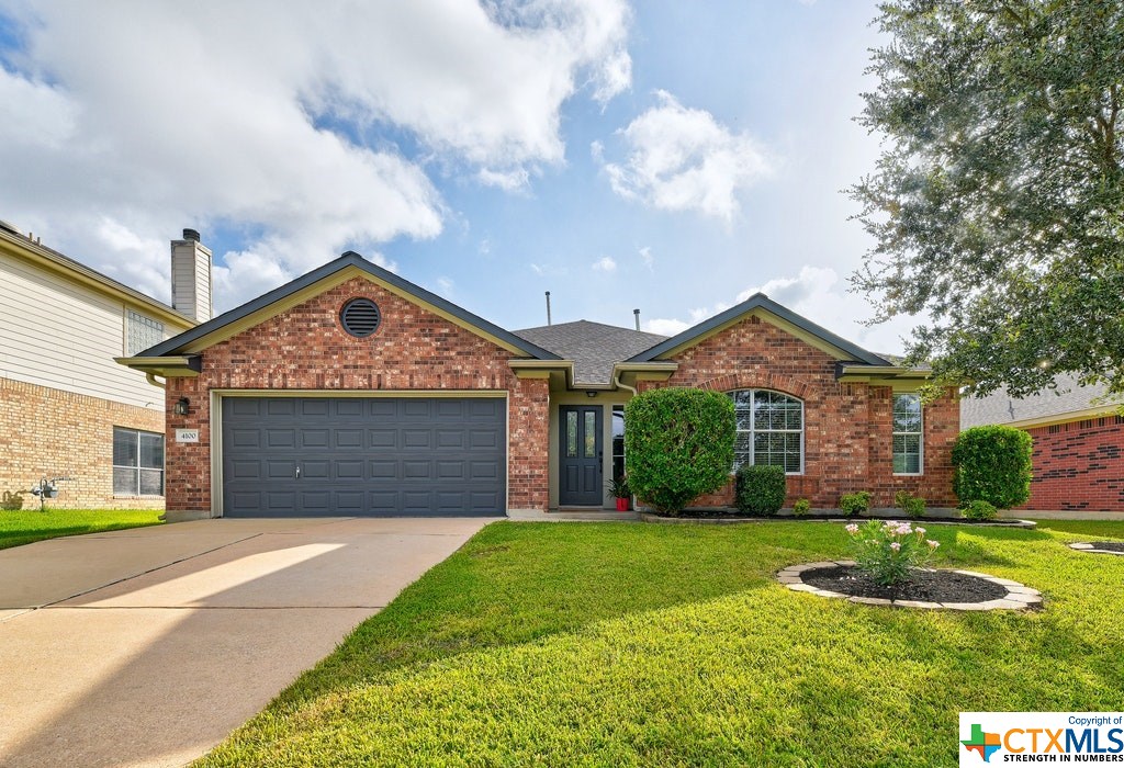 4100 Hidden Lake Crossing Pflugerville, TX 78660 - Photo 1 of 1 a front view of a house with garden