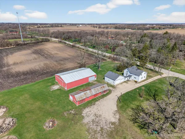 a view of a backyard with a patio and ocean view