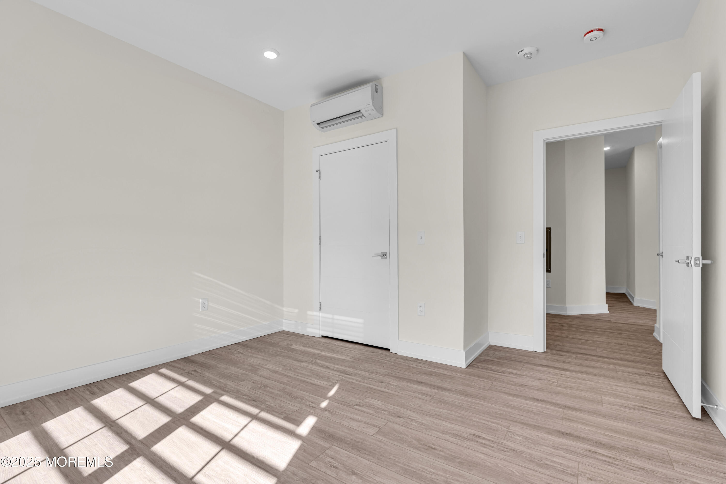 19 Carr Avenue, Unit 219 Keansburg, NJ 07734 - Photo 12 of 22 wooden floor in an empty room with a window