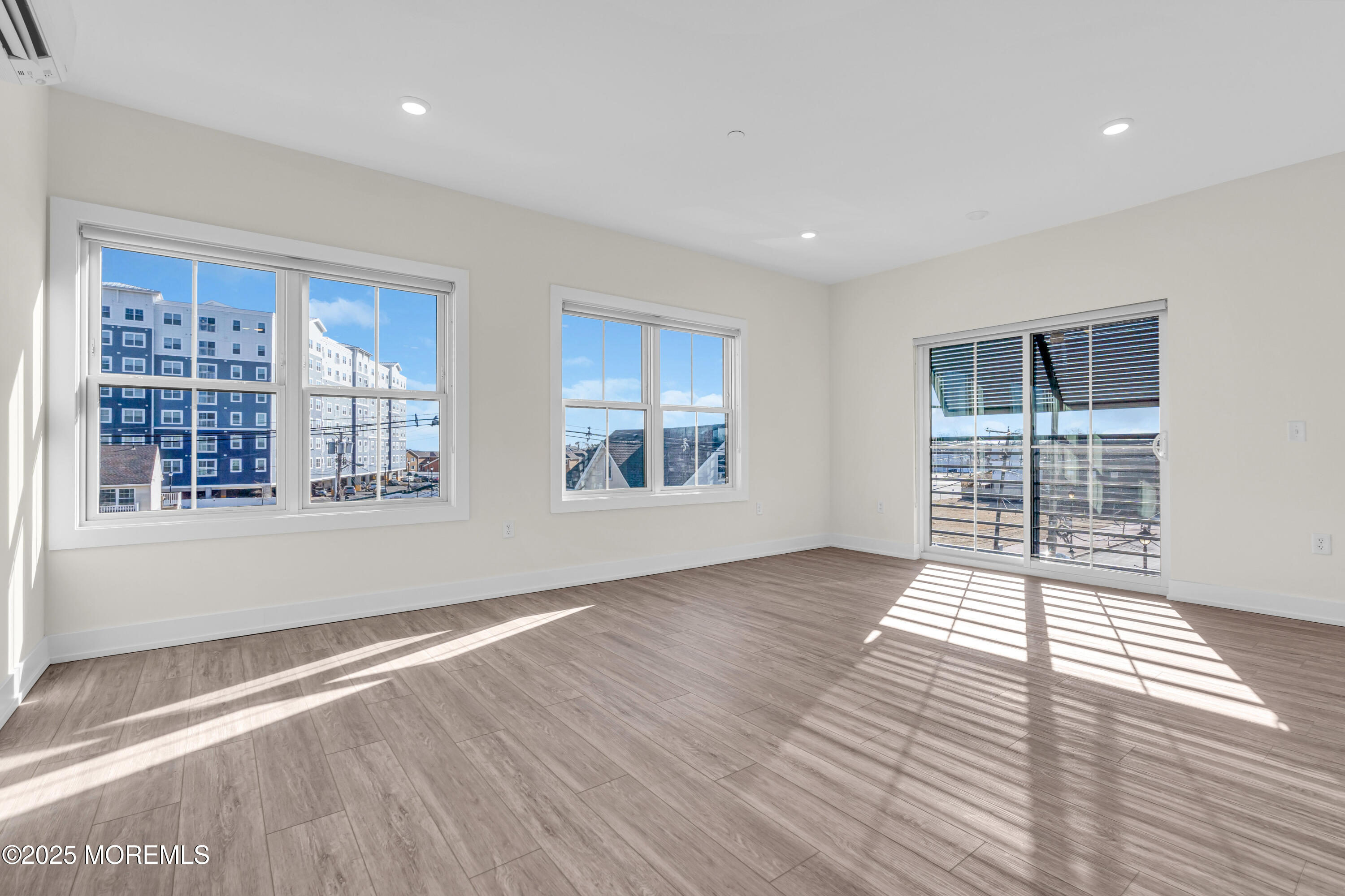 19 Carr Avenue, Unit 219 Keansburg, NJ 07734 - Photo 17 of 22 a view of an empty room with wooden floor and a window