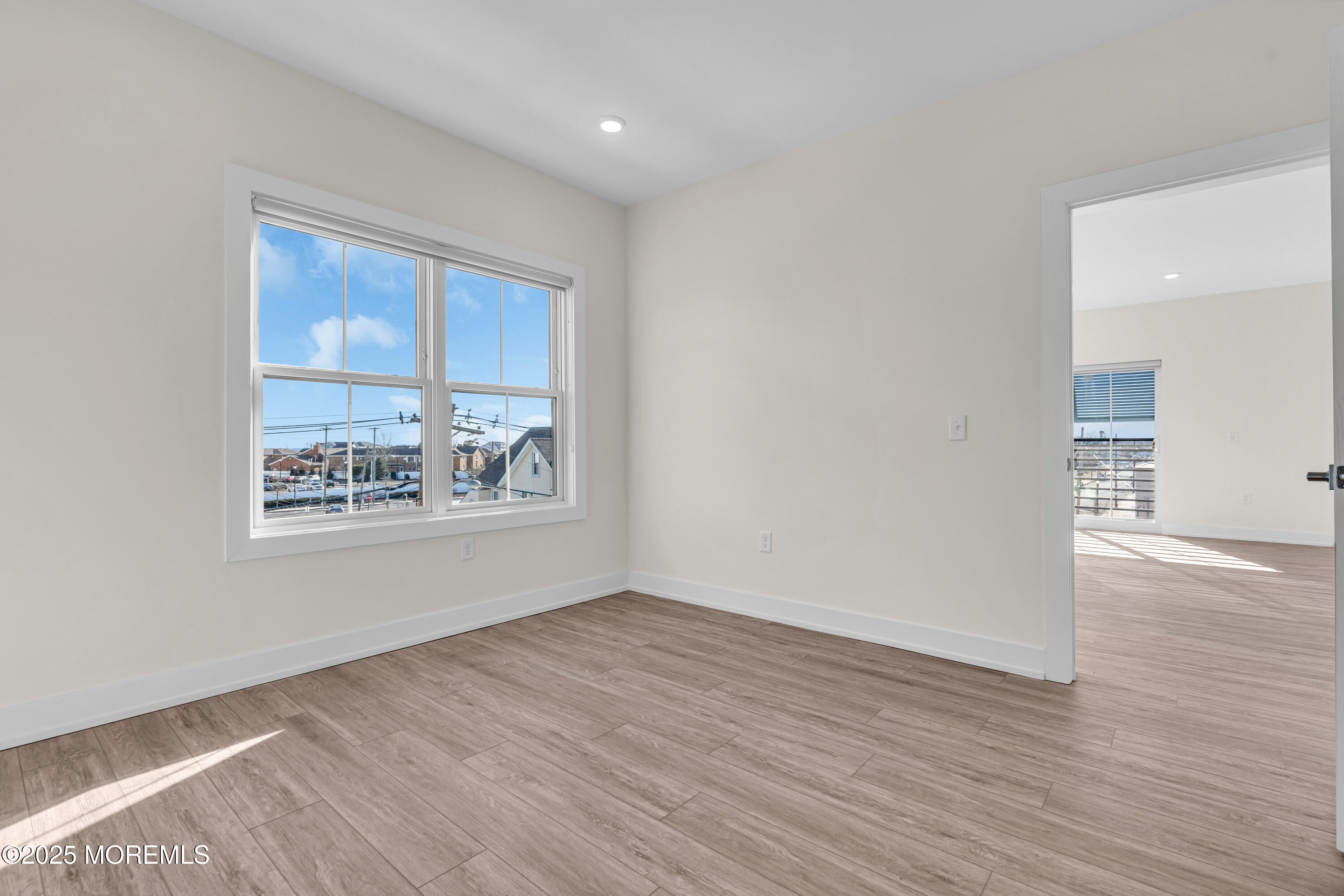 19 Carr Avenue, Unit 219 Keansburg, NJ 07734 - Photo 19 of 22 a view of an empty room with wooden floor and a window
