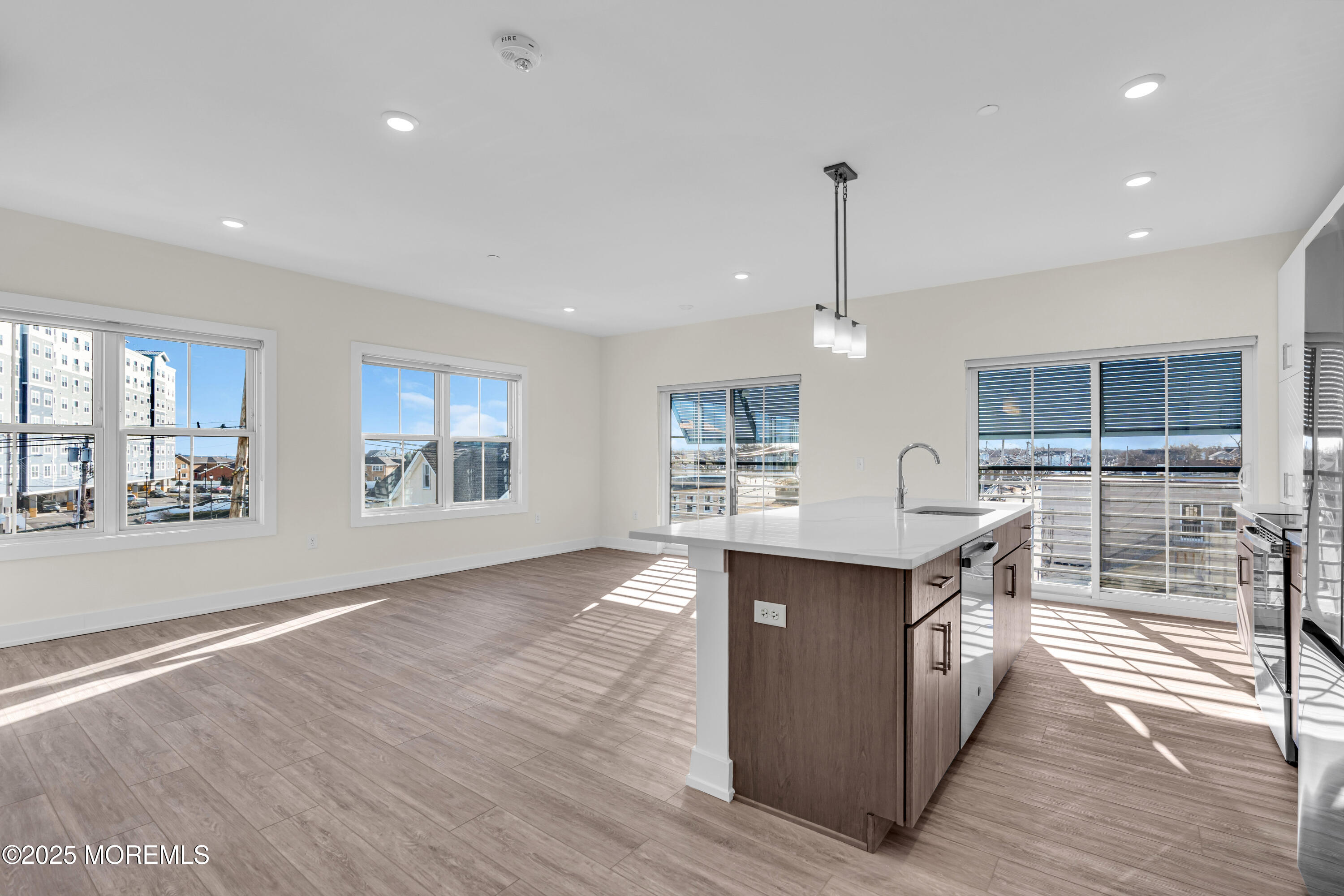 19 Carr Avenue, Unit 219 Keansburg, NJ 07734 - Photo 2 of 22 a kitchen with stainless steel appliances granite countertop a sink a stove and a wooden floors