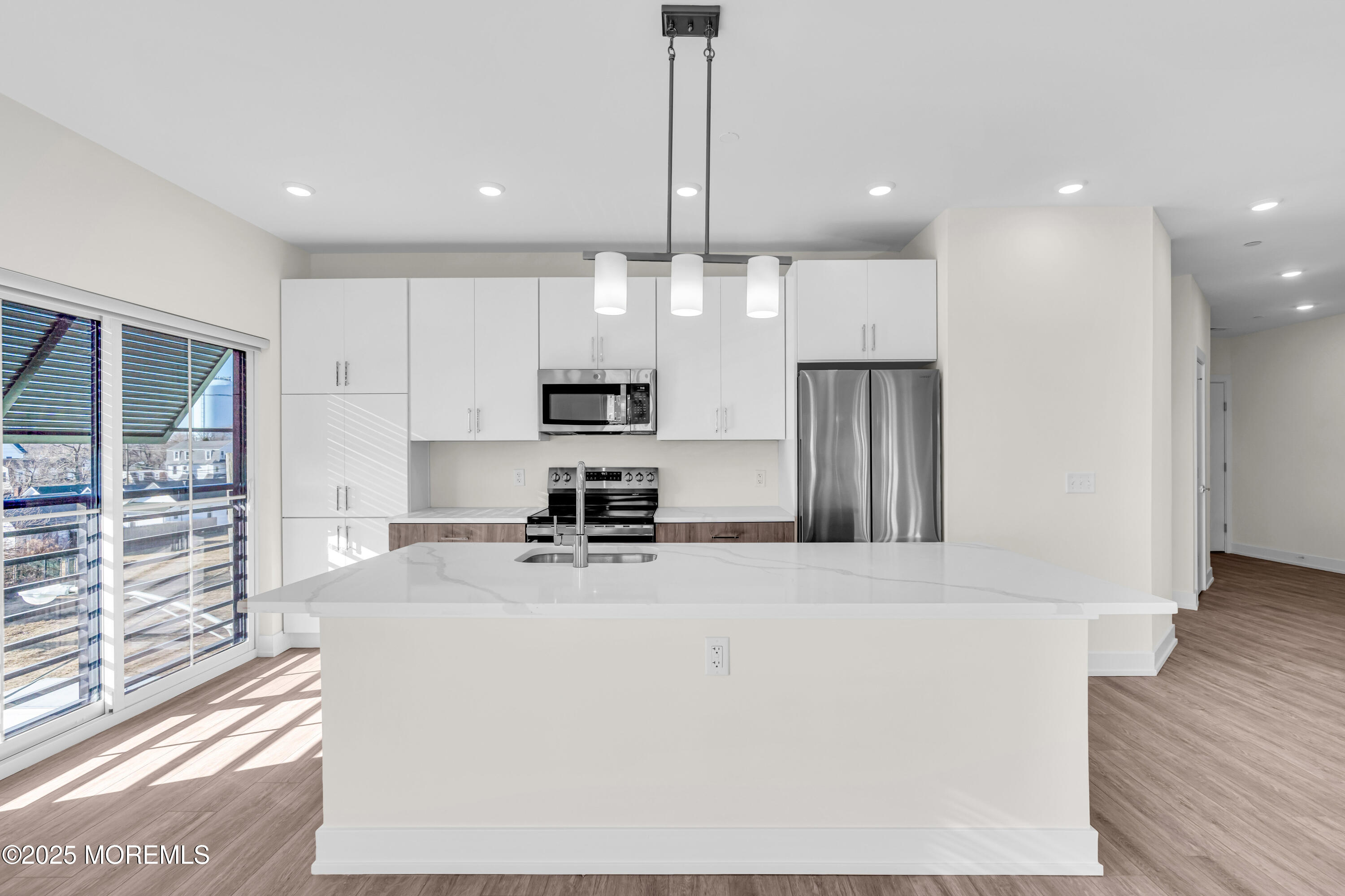 19 Carr Avenue, Unit 219 Keansburg, NJ 07734 - Photo 4 of 22 a large kitchen with stainless steel appliances a large counter top a stove a refrigerator and a sink