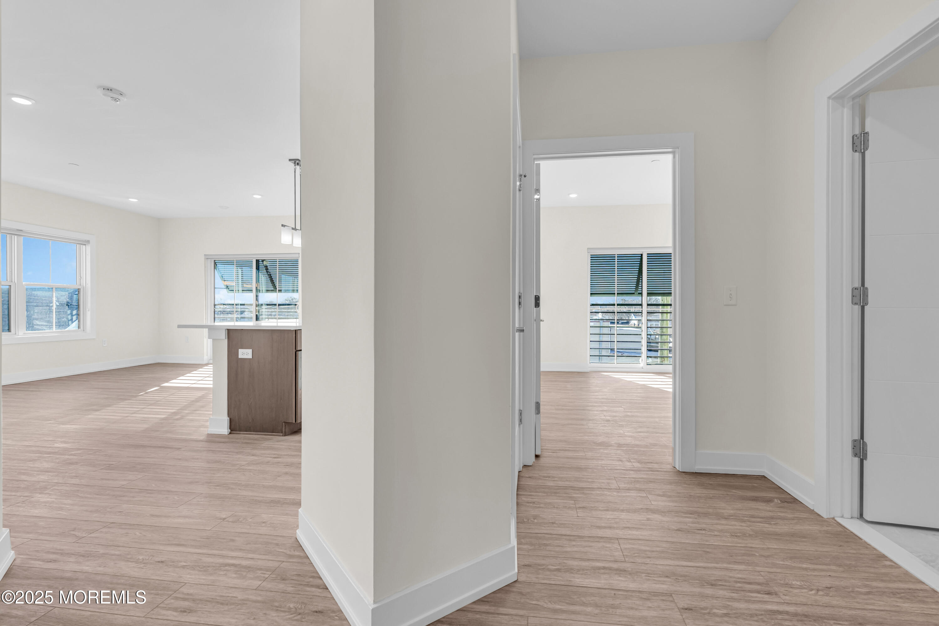 19 Carr Avenue, Unit 219 Keansburg, NJ 07734 - Photo 6 of 22 a view of a hallway with wooden floor and windows