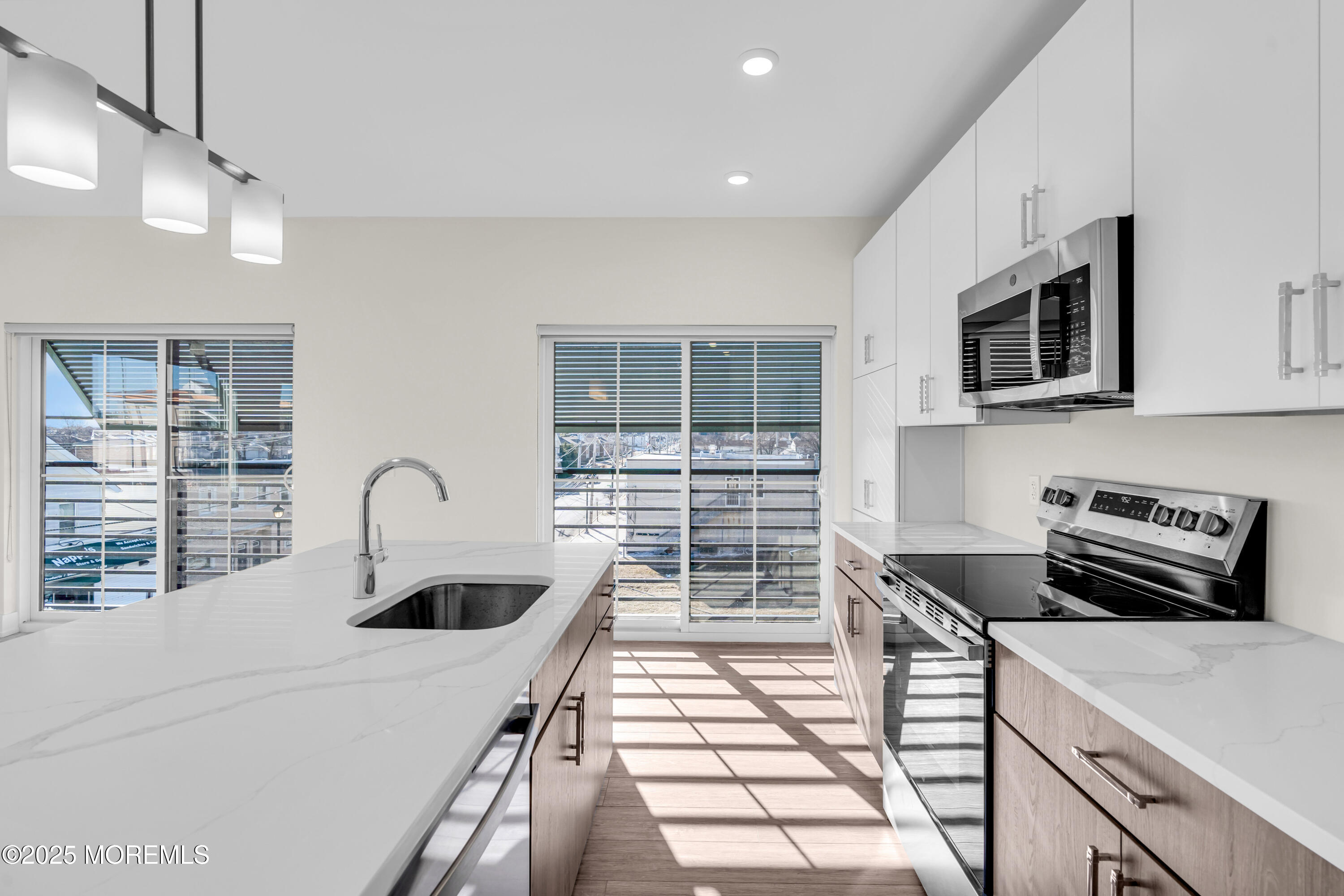 19 Carr Avenue, Unit 219 Keansburg, NJ 07734 - Photo 8 of 22 a kitchen with a sink a stove and cabinets