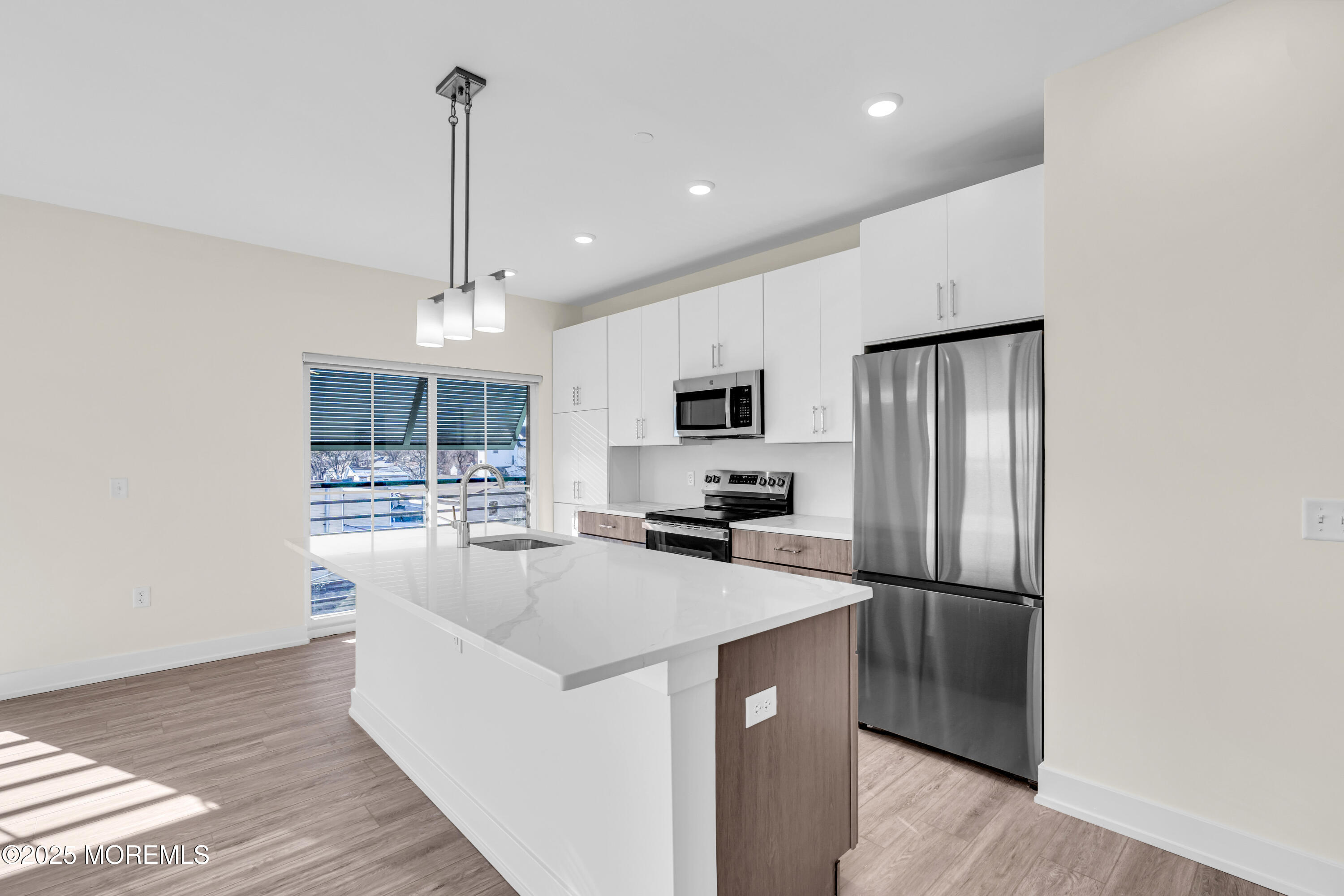19 Carr Avenue, Unit 219 Keansburg, NJ 07734 - Photo 9 of 22 a kitchen with stainless steel appliances a refrigerator sink and microwave