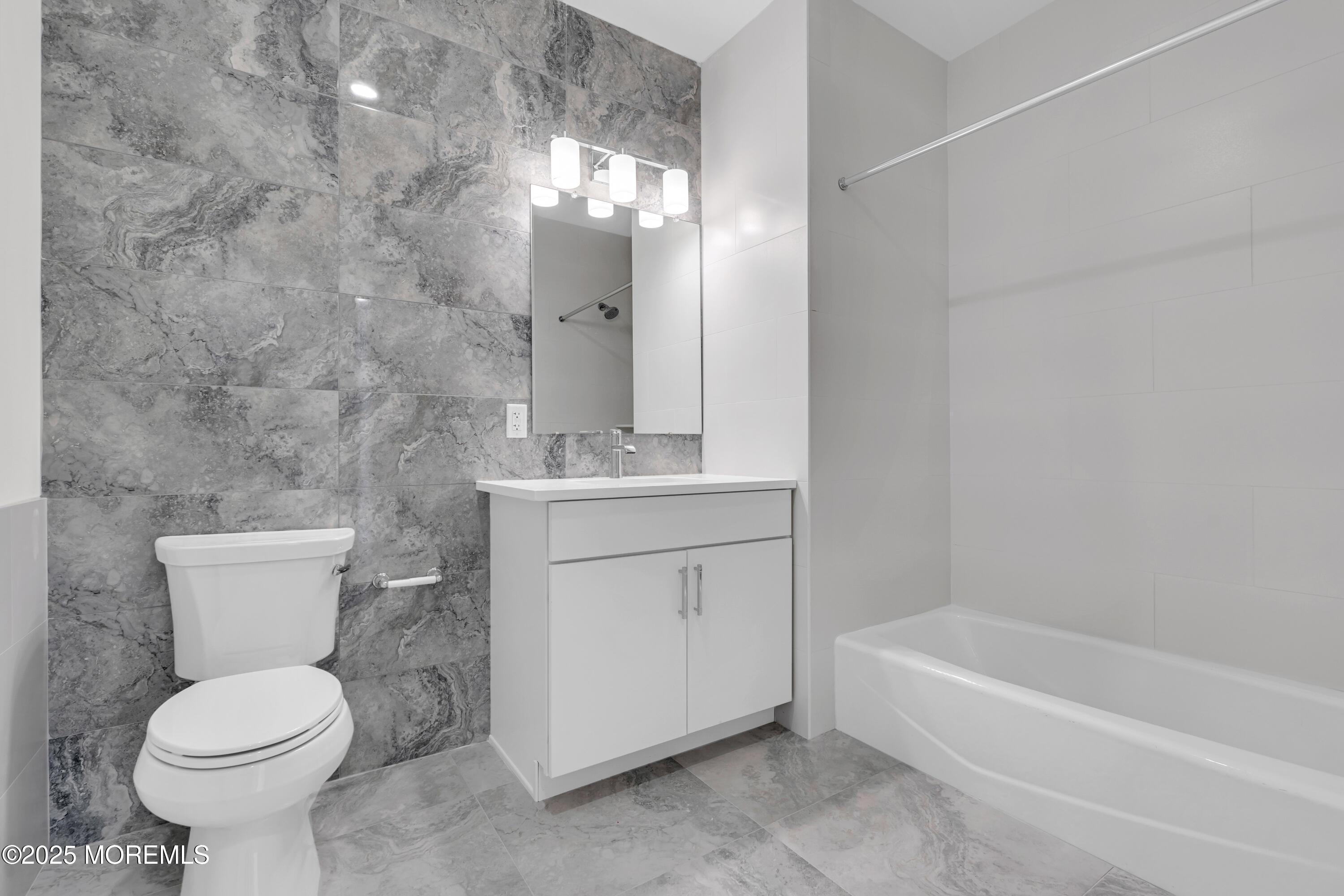 19 Carr Avenue, Unit 219 Keansburg, NJ 07734 - Photo 10 of 22 a bathroom with a sink a toilet and bathtub