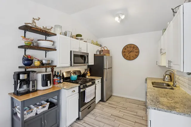 a kitchen with stainless steel appliances granite countertop a stove and a sink
