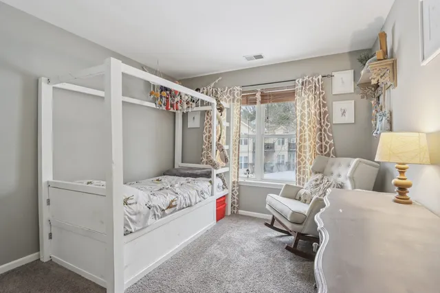 a bedroom with a bed couch and a window