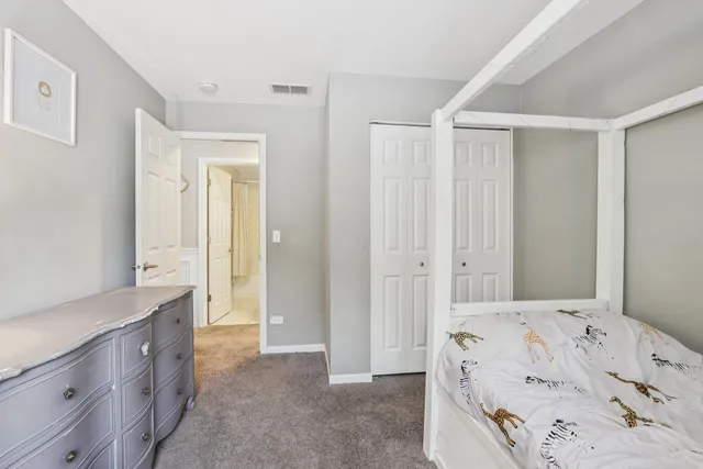 a spacious bedroom with a bed and a sink