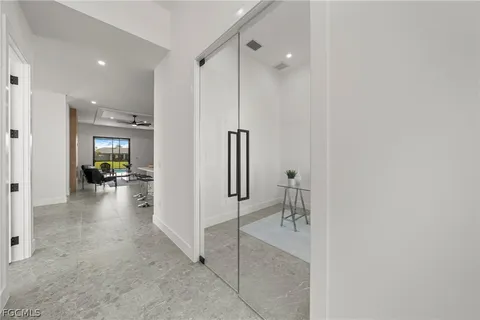 a view of a livingroom and a dining room with furniture and window