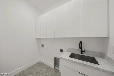 a living room with a floor to ceiling window and wooden floor