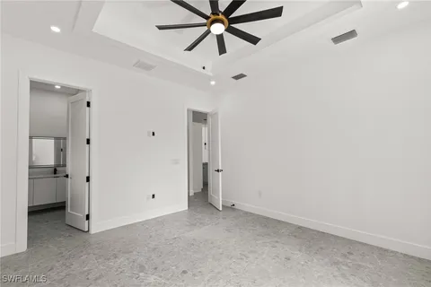 a view of a hallway with a ceiling fan