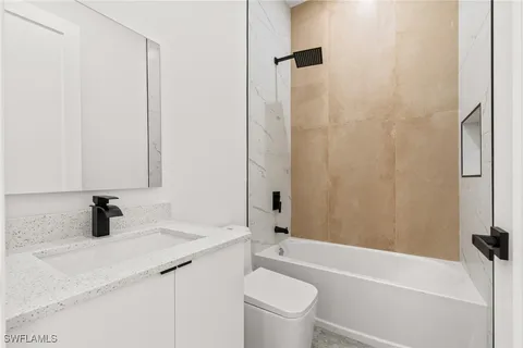 a bathroom with a sink a toilet and a bathtub