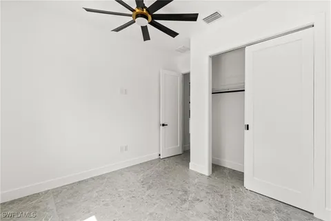 a view of a hallway with a ceiling fan