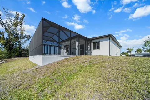 a view of a house with backyard and sitting area