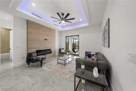 a living room with furniture and a ceiling fan