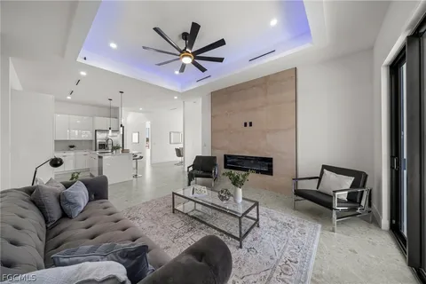 a living room with furniture and a chandelier