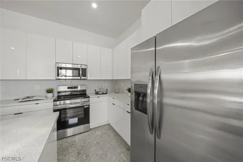 a kitchen with cabinets and stainless steel appliances