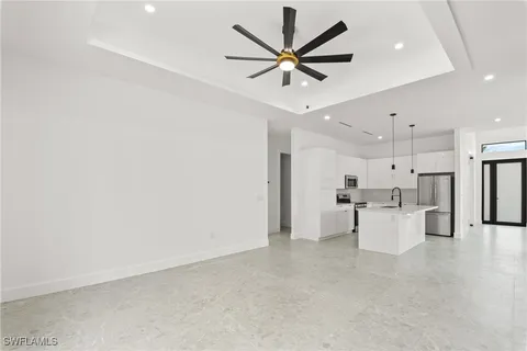 a view of a kitchen with a sink and microwave
